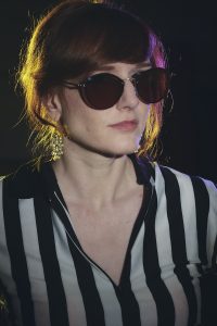 Gal is wearing large dark sunglasses